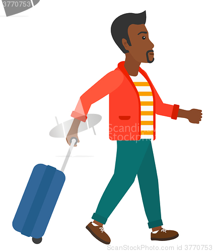 Image of Man walking with suitcase.