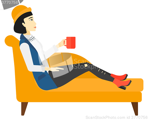 Image of Woman lying with cup of tea.