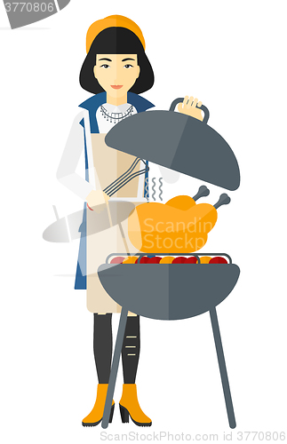 Image of Woman preparing barbecue.