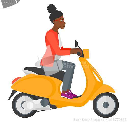 Image of Woman riding scooter.