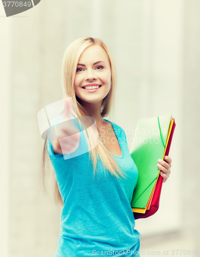 Image of smiling student with folders