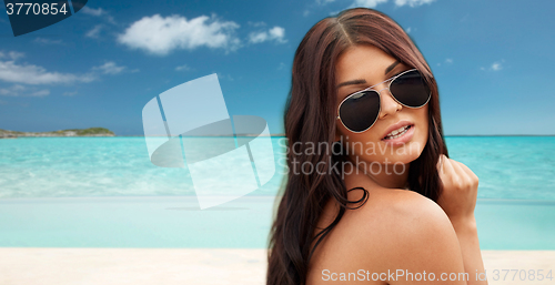 Image of young woman with sunglasses on beach