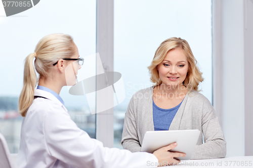 Image of doctor with tablet pc and woman at hospital