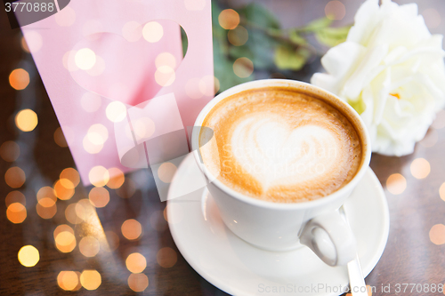 Image of close up of greeting card with heart and coffee