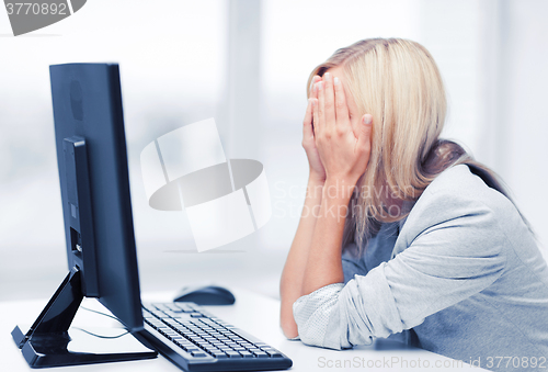 Image of stressed woman with computer