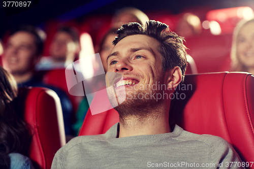 Image of happy young man watching movie in theater