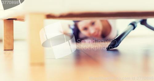 Image of close up of woman with vacuum cleaner at home