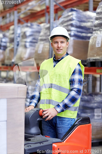 Image of man on forklift loading boxes at warehouse