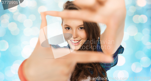 Image of happy teenage girl making frame of fingers