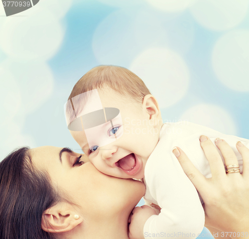 Image of laughing baby playing with mother