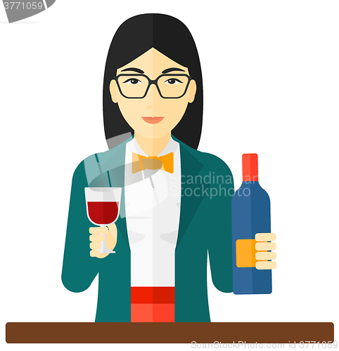 Image of Cheerful woman with bottle and glass.