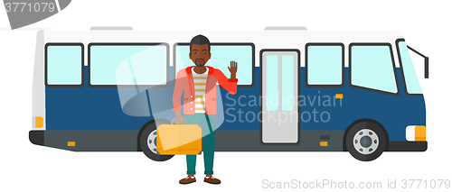 Image of Man standing near bus.