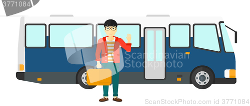 Image of Man standing near bus.