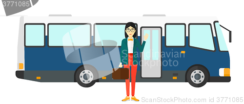 Image of Woman standing near bus.