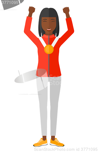 Image of Athlete with medal and hands raised.