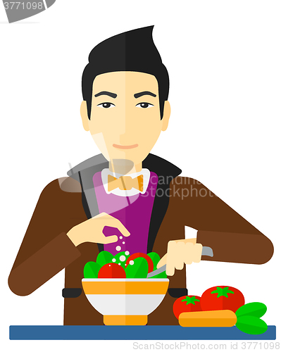 Image of Man cooking meal.