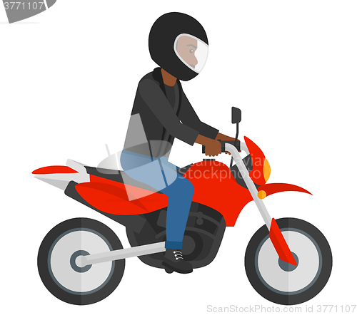 Image of Man riding motorcycle.