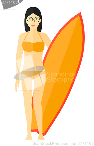 Image of Surfer holding surfboard.