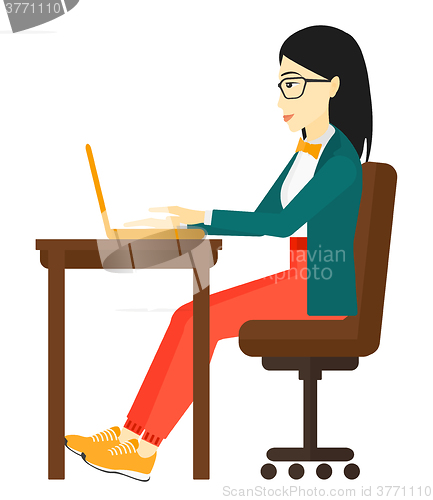 Image of Woman working at laptop.