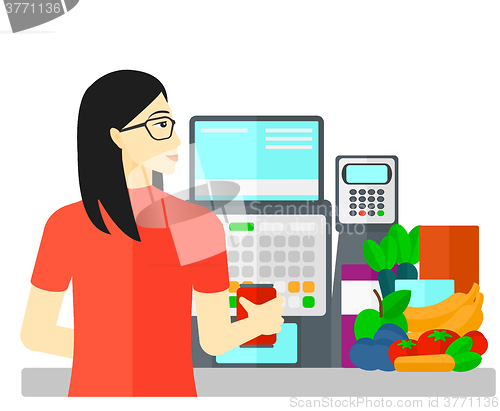 Image of Cashier at supermarket checkout.