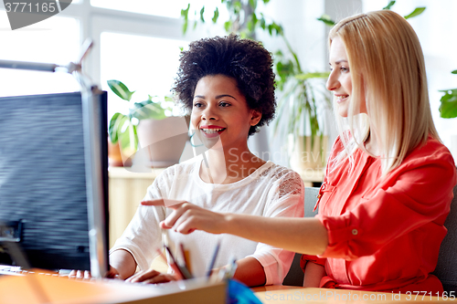 Image of happy women or students with computer in office