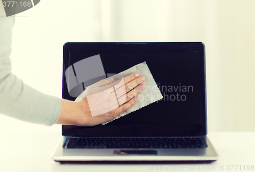Image of close up of woman hand cleaning laptop screen