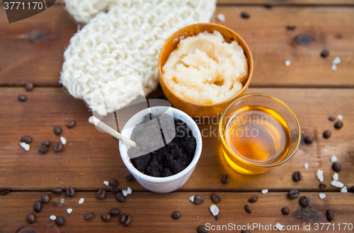 Image of close up of coffee scrub in cup and honey on wood