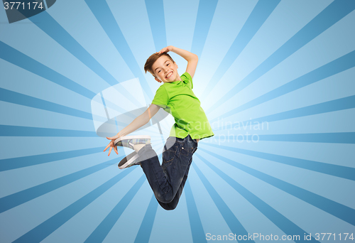 Image of smiling boy jumping in air