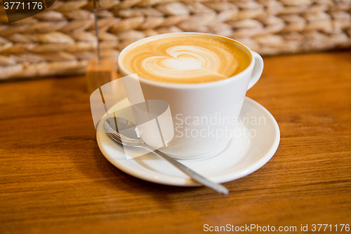 Image of close up of coffee cup with heart shape drawing