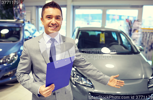 Image of happy man at auto show or car salon