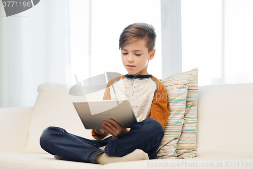Image of boy with tablet computer at home