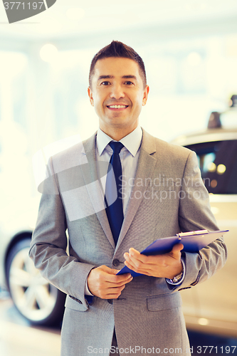 Image of happy man at auto show or car salon