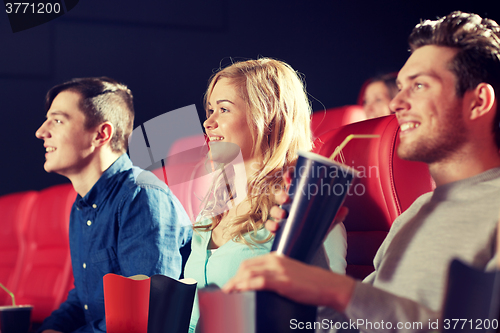 Image of happy friends watching movie in theater