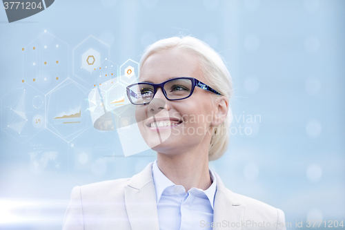 Image of young smiling businesswoman in eyeglasses outdoors
