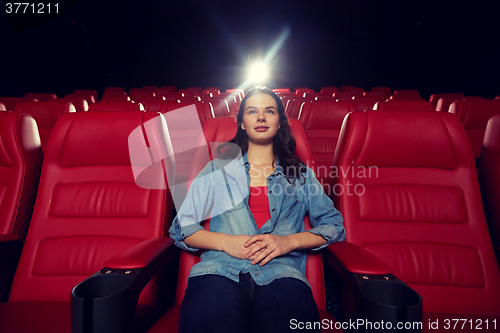 Image of young woman watching movie in theater