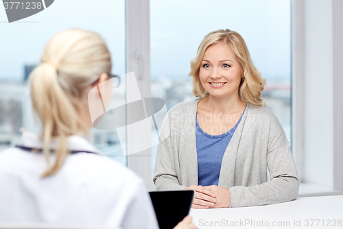 Image of doctor with tablet pc and woman at hospital