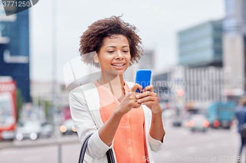 Image of happy african businesswoman with smartphone