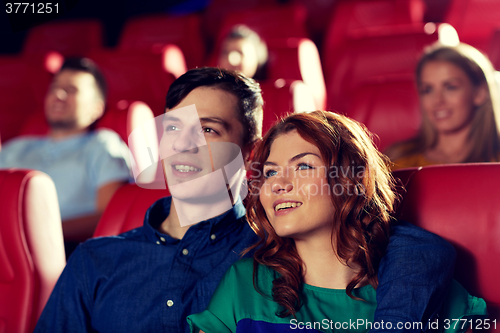 Image of happy friends watching movie in theater