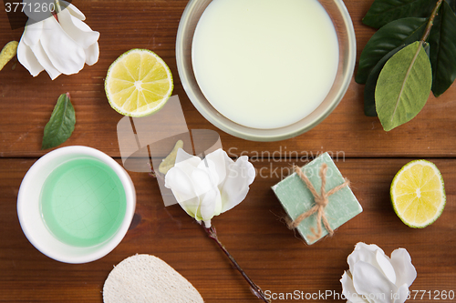 Image of close up of body lotion, cream and soap on wood