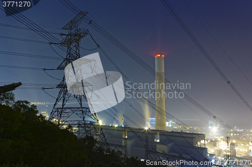 Image of power station at night with smoke 