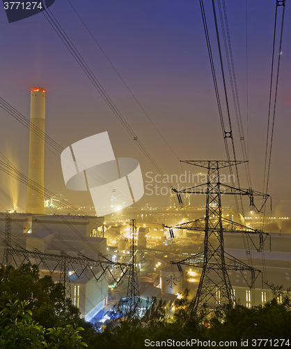 Image of power station at night with smoke 