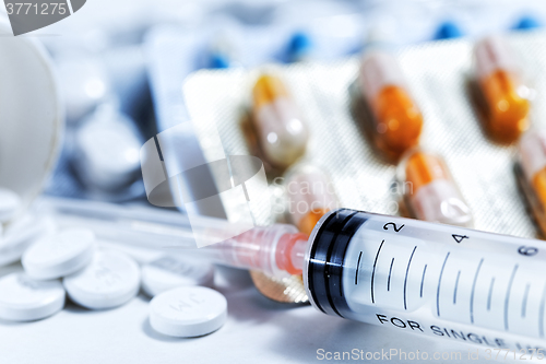 Image of Syringe with glass vials and medications pills drug