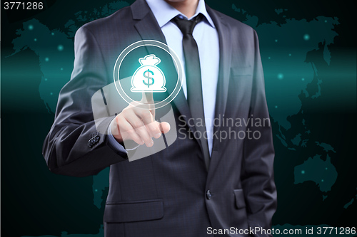 Image of Businessman presses digital interface dollar sign 