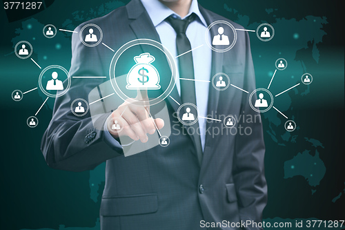 Image of Businessman presses digital interface dollar sign 