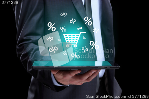 Image of Businessman hand touch online shopping icons on a tablet