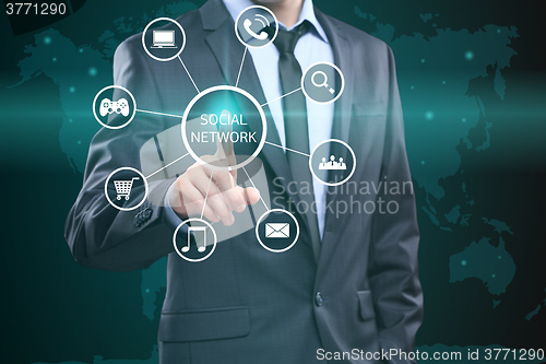 Image of business, technology, internet and networking concept - businessman pressing button with Social Network on virtual screens. 