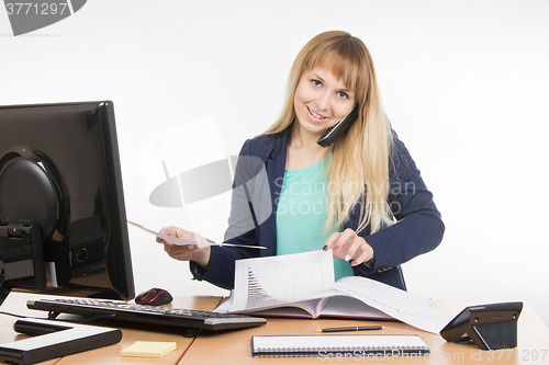 Image of  Business woman talking on the phone and looking for the desired paper documents