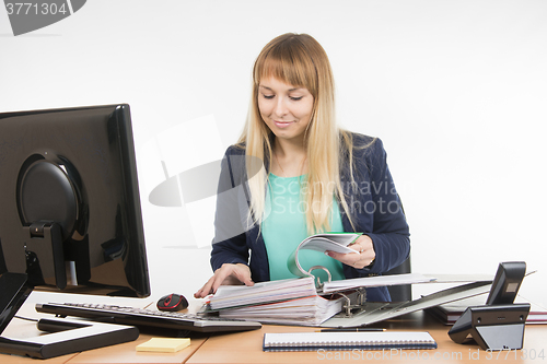 Image of Secretary leafing through paper in a large folder