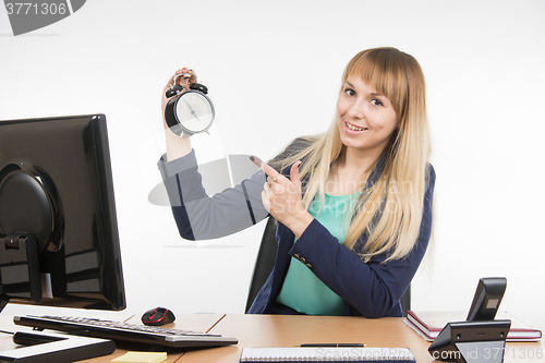 Image of Office specialist in after-hours shows the clock