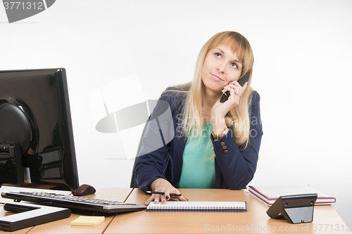 Image of Angry business woman talking on the phone and looking up